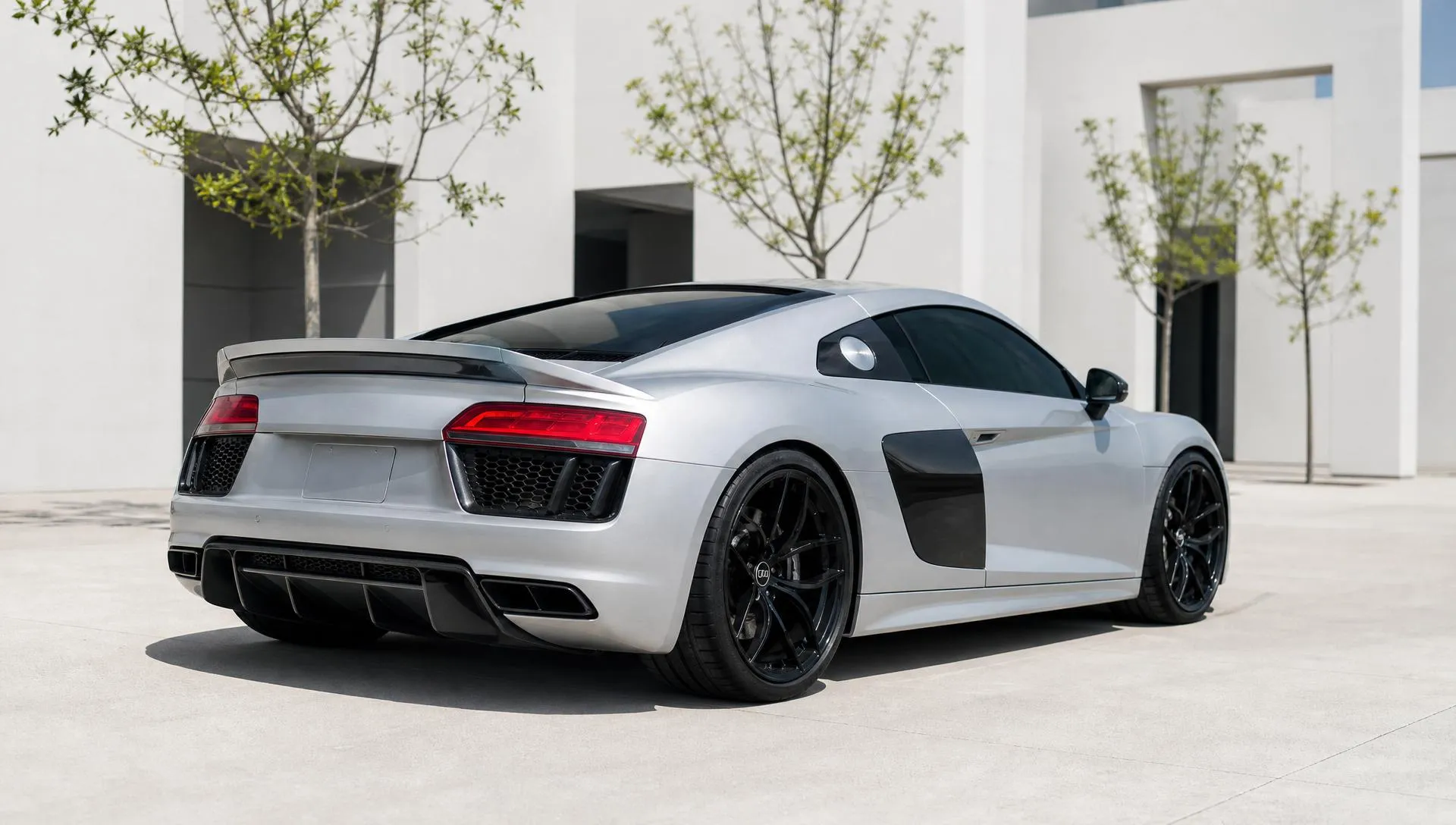 Silver Audi R8 sports car with tinted windows in the sun
